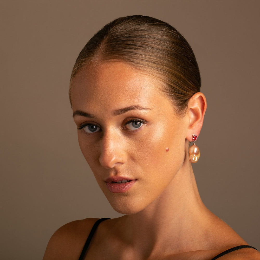 Vibrant pink tourmaline and baroque pearl drop earring in 14K white gold with high-polish basket setting