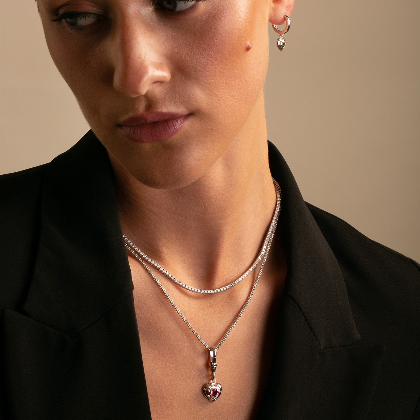 14k Gold Seagreen Tourmaline Heart Gypset Hoop Earrings styled on model with diamond tennis necklace and pink tourmaline heart necklace
