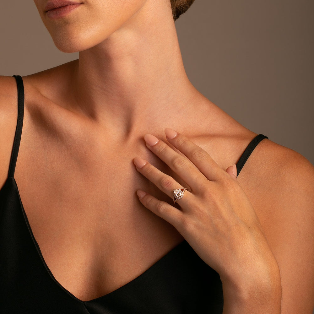 14k Rose Gold Sparkling Diamond Split Shank ring featuring a 1.33 ct Pear Shaped Forever One Moissanite Center on model