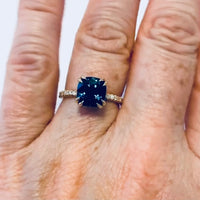 Double Claw 18K Yellow Gold Cushion Cut Peacock Blue Spinel Engagement Ring on model view