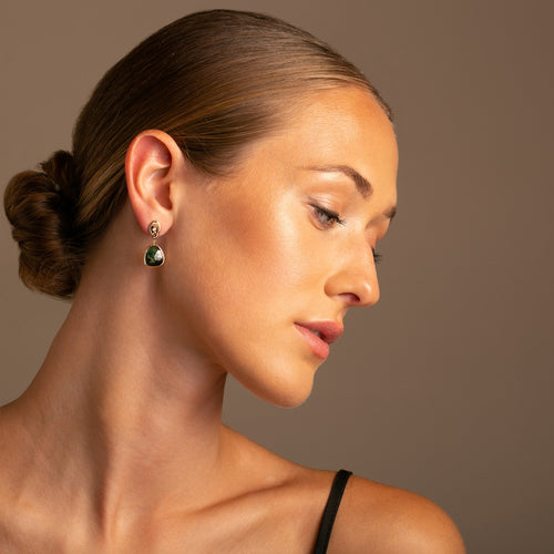 One of a Kind 14K Yellow Gold and Diamond  earring on model   -, each radiating a captivating green hue that is both vibrant and alluring.