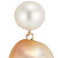 Close up of white round pearl and golden baroque pearl