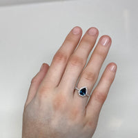 18K White Gold Diamond Halo Teardrop Montana Sapphire Ring on hand