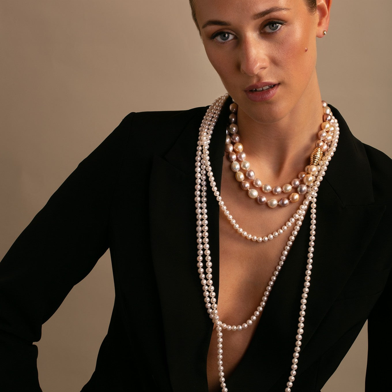 On-model: 100 cm white freshwater pearls layered as a three row necklace, and layered with a multicolor baroque necklace