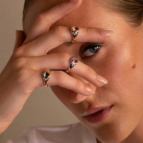 A pinky ring stack on model featuring our  modern colored gemstone pinky rings