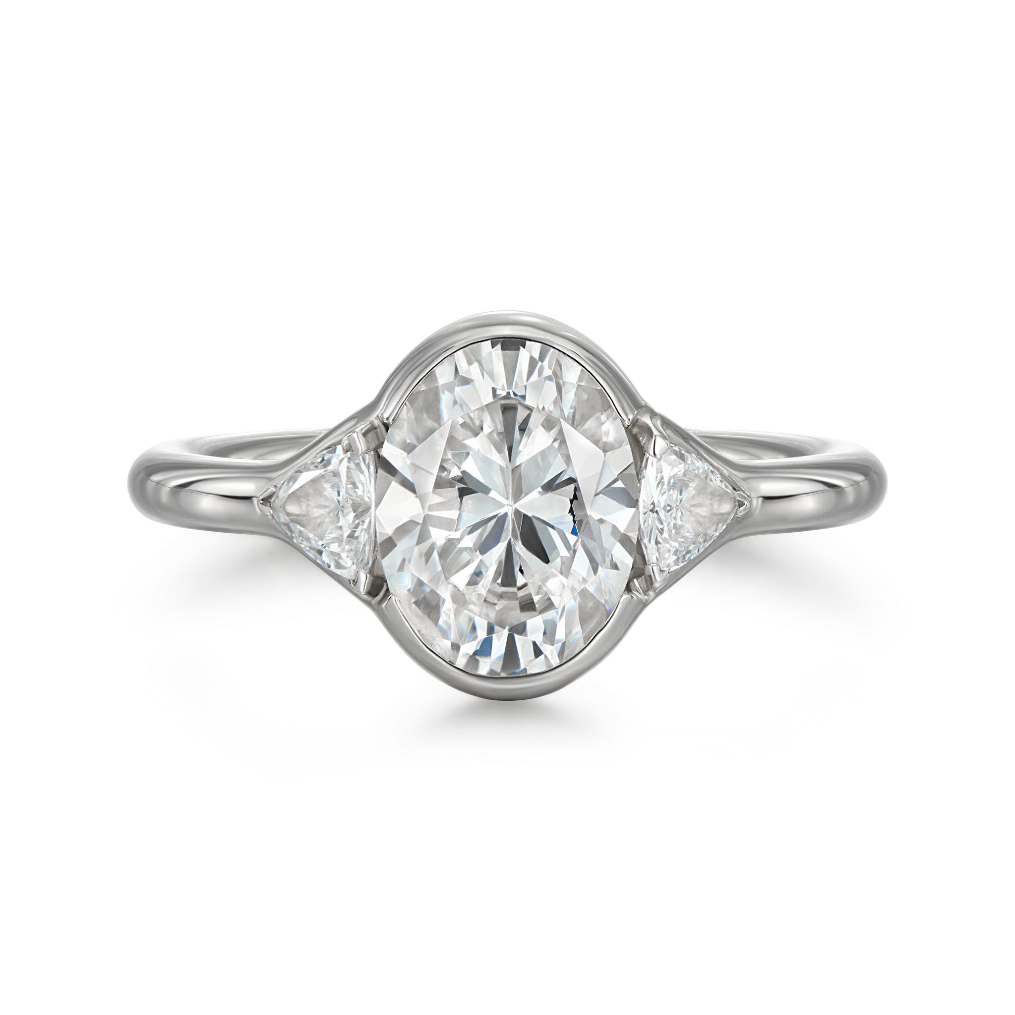 Top view of Cael oval bezel engagement ring with trillion cut side diamonds in 18k white gold