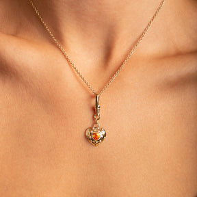 14k Yellow Gold Orange Spessartite Garnet Diamond Heart Charm with Vintage-Inspired Dog Clip on modlel  - close up view