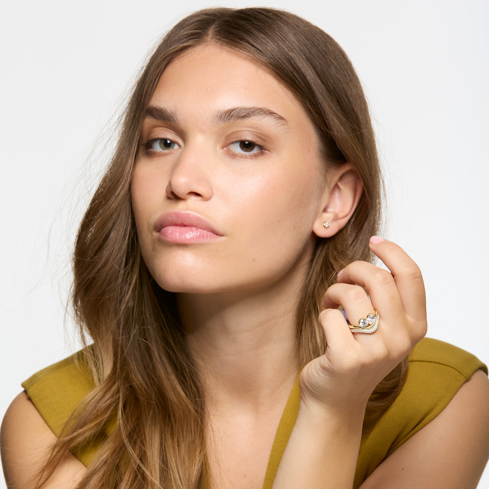 Wave Toi et Moi engagement ring with pear and round brilliant diamonds in signature hybrid bezel claw setting.  Shown here on model with matching Diamond Band