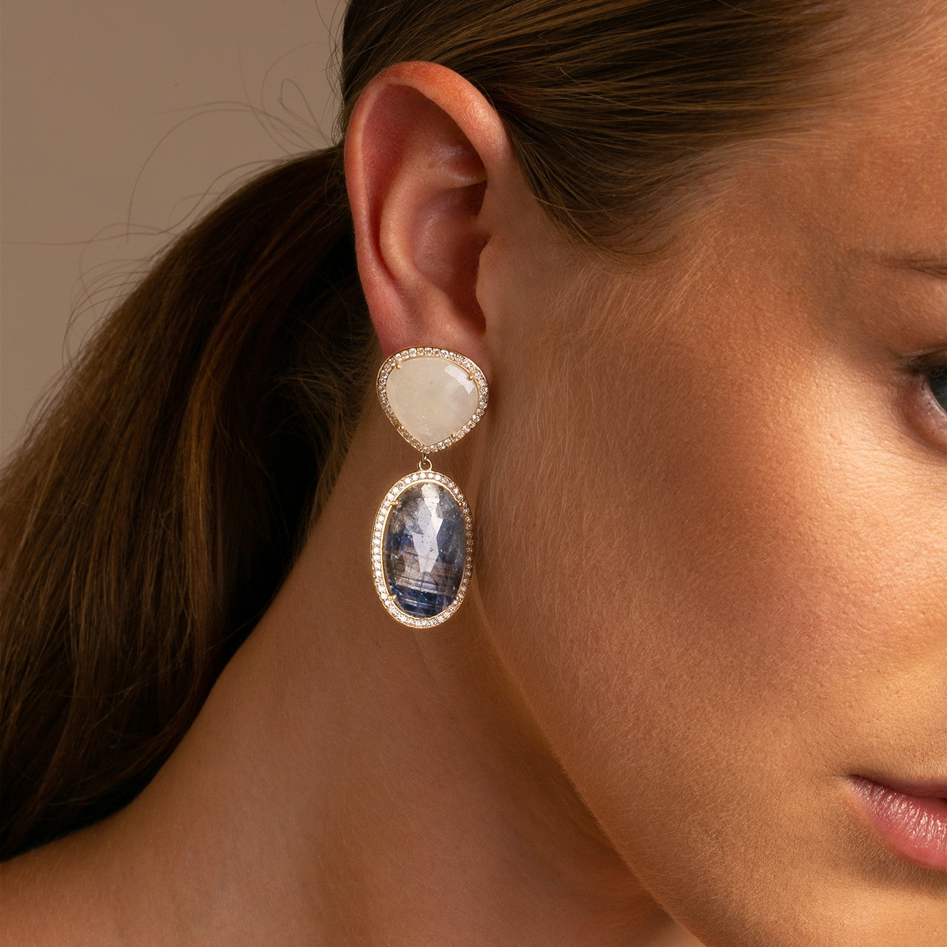 14k Yellow Gold Blue Sapphire Oval Shaped Slice and Cream Sapphire Slice with Diamond Halo Earrings detail Shot on Model 