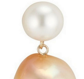 Close up of white round pearl and golden baroque pearl