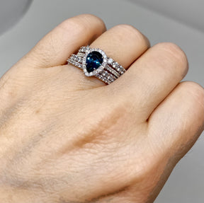 18K White Gold Diamond Halo Teardrop Montana Sapphire Ring stacked with diamond wedding bands  - on model